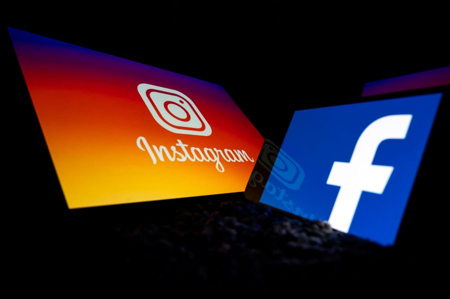 This picture taken on October 5, 2020 in Toulouse, southwestern France, shows logos of US social networks Facebook and Instagram on the screens of a tablet and a mobile phone. (Lionel Bonaventure/AFP via Getty Images)