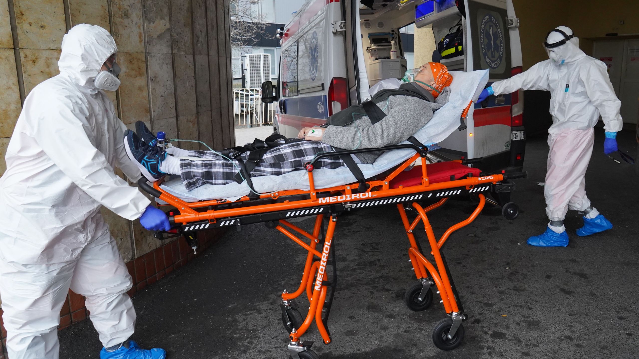 Two men in protective suits transport a coronavirus COVID-19 infected patient with an ambulance to a hospital in Warsaw, Poland, on Nov. 7, 2020, on the first day of the new partial lockdown. Poland enters another round of anti-virus restrictions, including the closure of cinemas, cultural institutions and most shops in shopping centres, as well as a total switch to remote learning, as the EU country of 38 million people saw a new 24-hour record of 24,692 new coronavirus cases on Nov. 4, 2020. (JANEK SKARZYNSKI / AFP via Getty Images)