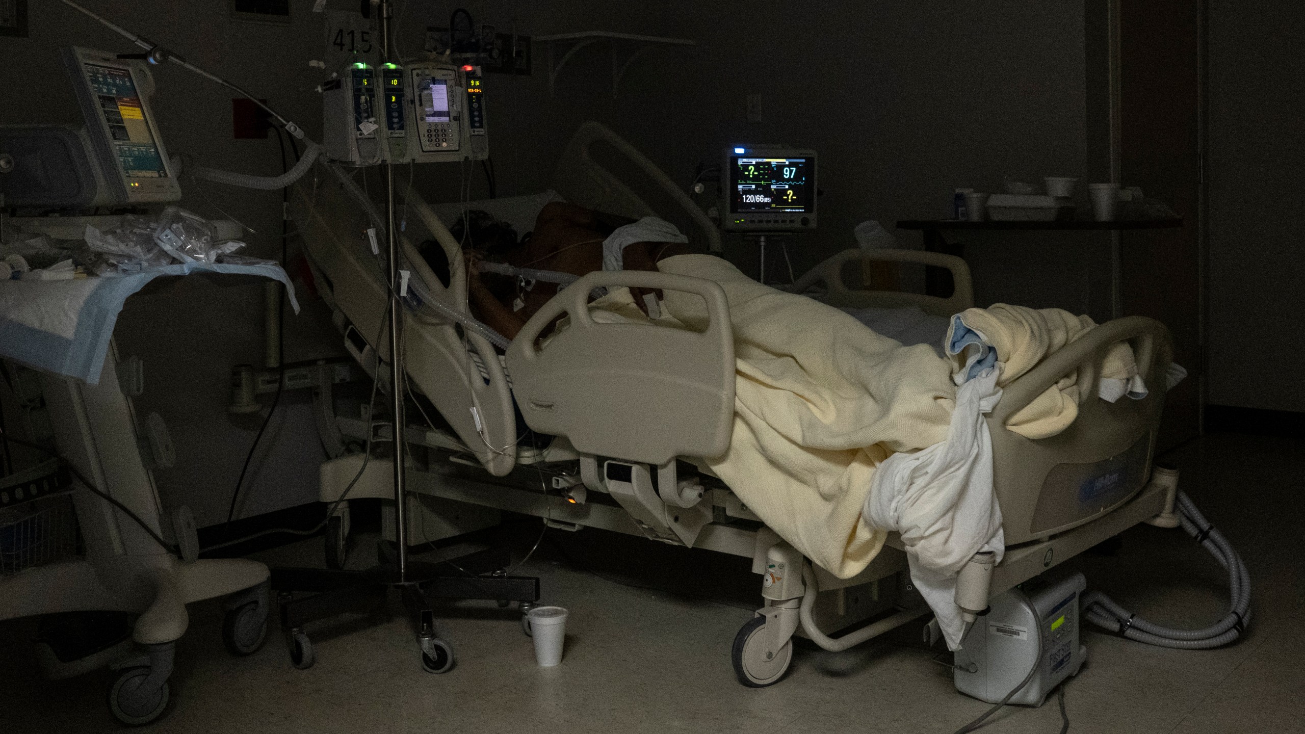 A patient is seen lying on a bed in the COVID-19 intensive care unit (ICU) on New Year's Eve at the United Memorial Medical Center on December 31, 2020 in Houston, Texas. (Photo by Go Nakamura/Getty Images)