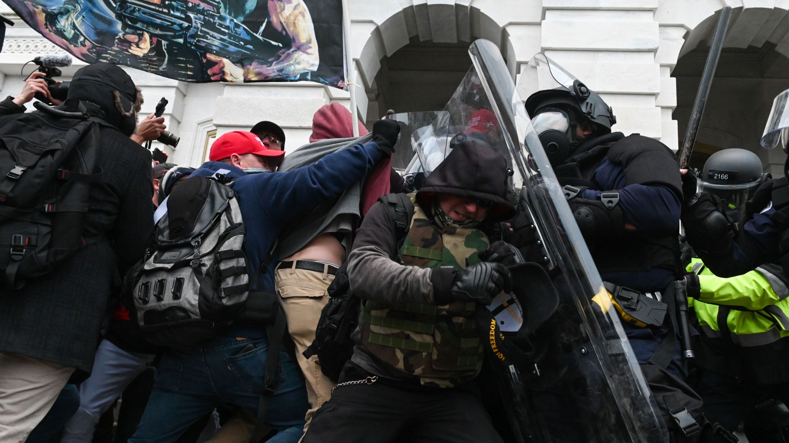 Riot police push back a crowd of supporters of President Donald Trump after they stormed the U.S. Capitol building on Jan. 6, 2021. (Roberto Schmidt / AFP / Getty Images)