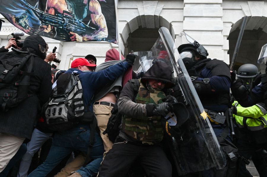 Riot police push back a crowd of supporters of President Donald Trump after they stormed the U.S. Capitol building on Jan. 6, 2021. (Roberto Schmidt / AFP / Getty Images)