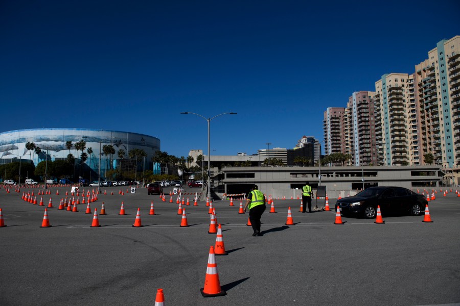 Vehicles drive to a post-vaccine recovery area after at a COVID-19 vaccination site on Feb.22, 2021 in Long Beach. (PATRICK T. FALLON/AFP via Getty Images)