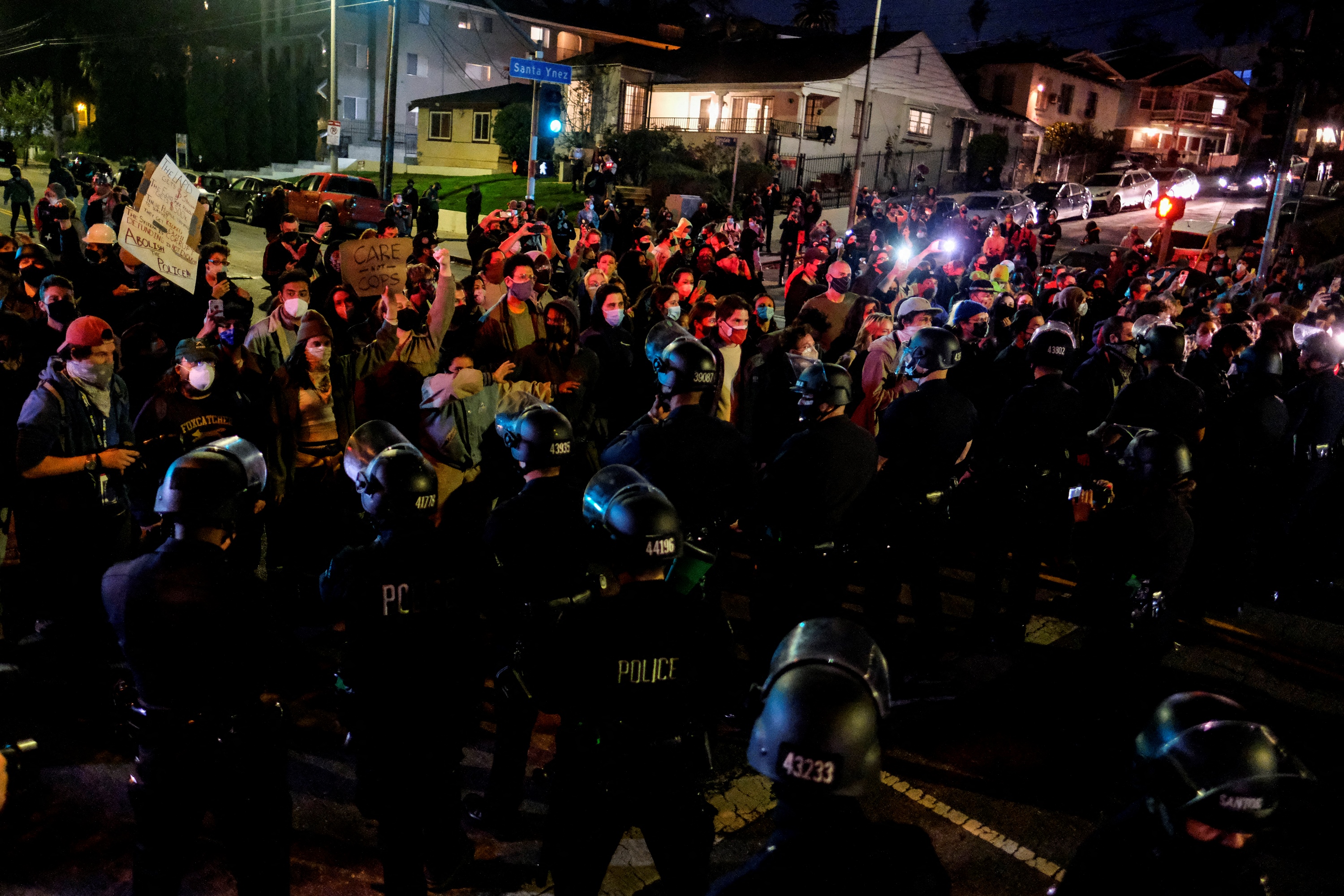 Activists and supporters of residents of a homeless encampment confront police at Echo Park Lake on March 24, 2021, ahead of a planned and announced clearing of the encampment (RINGO CHIU / AFP / Getty Images)