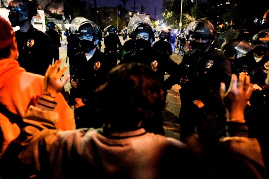 Activists and supporters of residents of a homeless encampment confront police at Echo Park Lake in Los Angeles late on March 24, 2021, ahead of a planned and announced clean-up of the encampment. (Ringo Chiu / AFP / Getty Images)