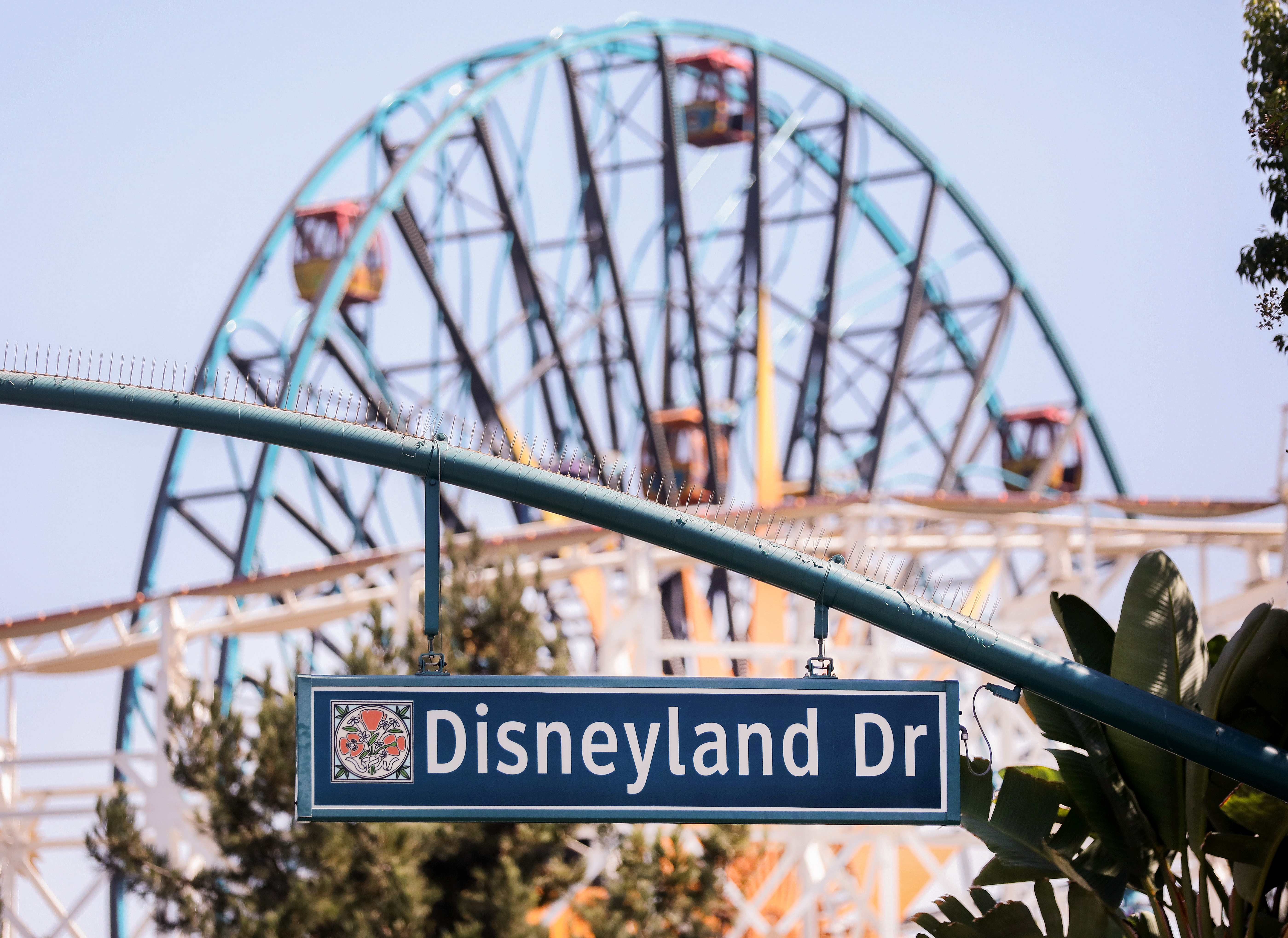 A sign for Disneyland Drive hangs near empty amusement rides on Sept. 30, 2020, in Anaheim, California.(Mario Tama/Getty Images)