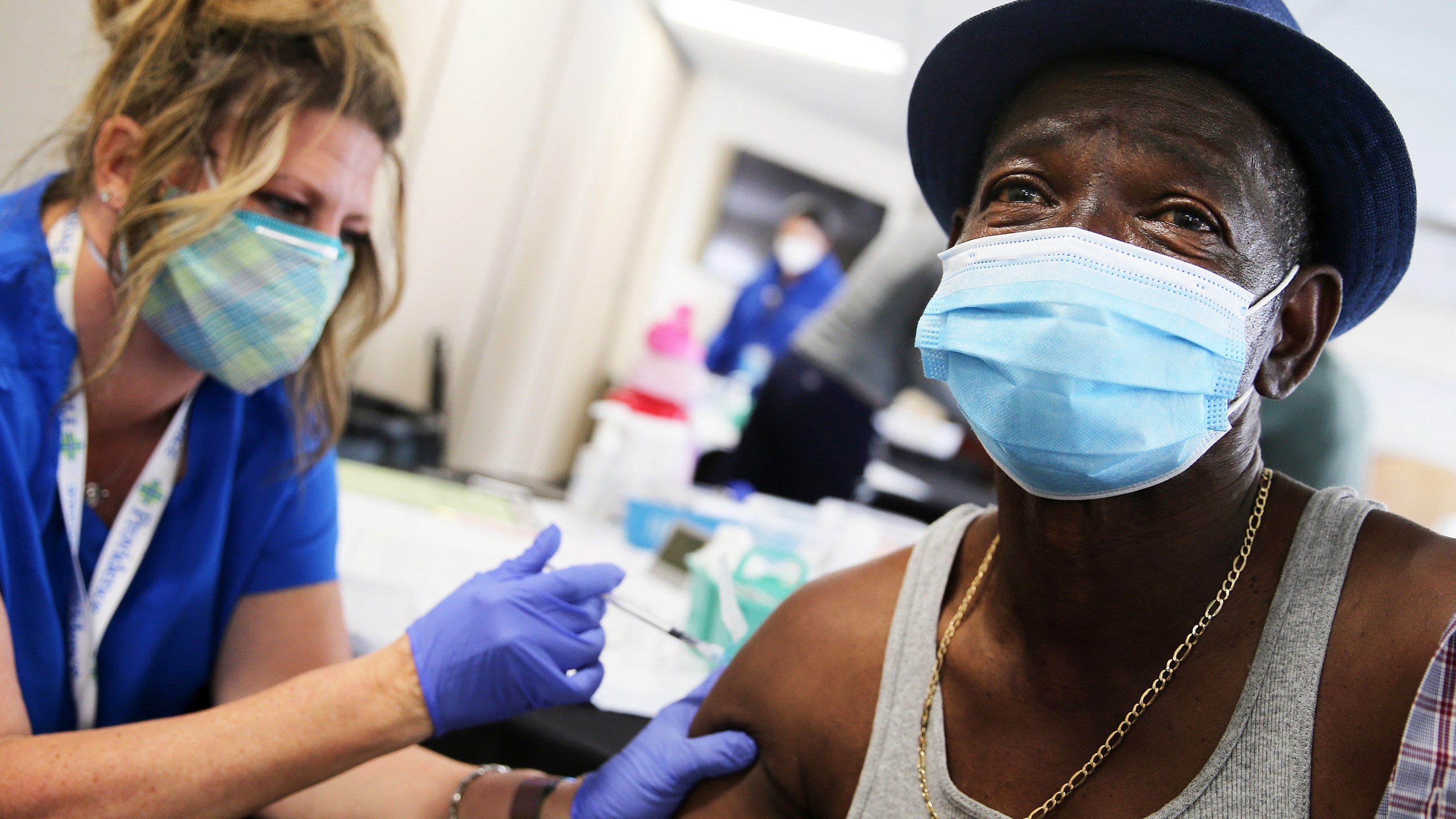 Larry Green (R) receives his second dose of the Moderna COVID-19 vaccine from registered nurse Teresa Frey at Lincoln Memorial Congregational Church UCC on March 12, 2021 in Los Angeles, California. (Mario Tama/Getty Images)