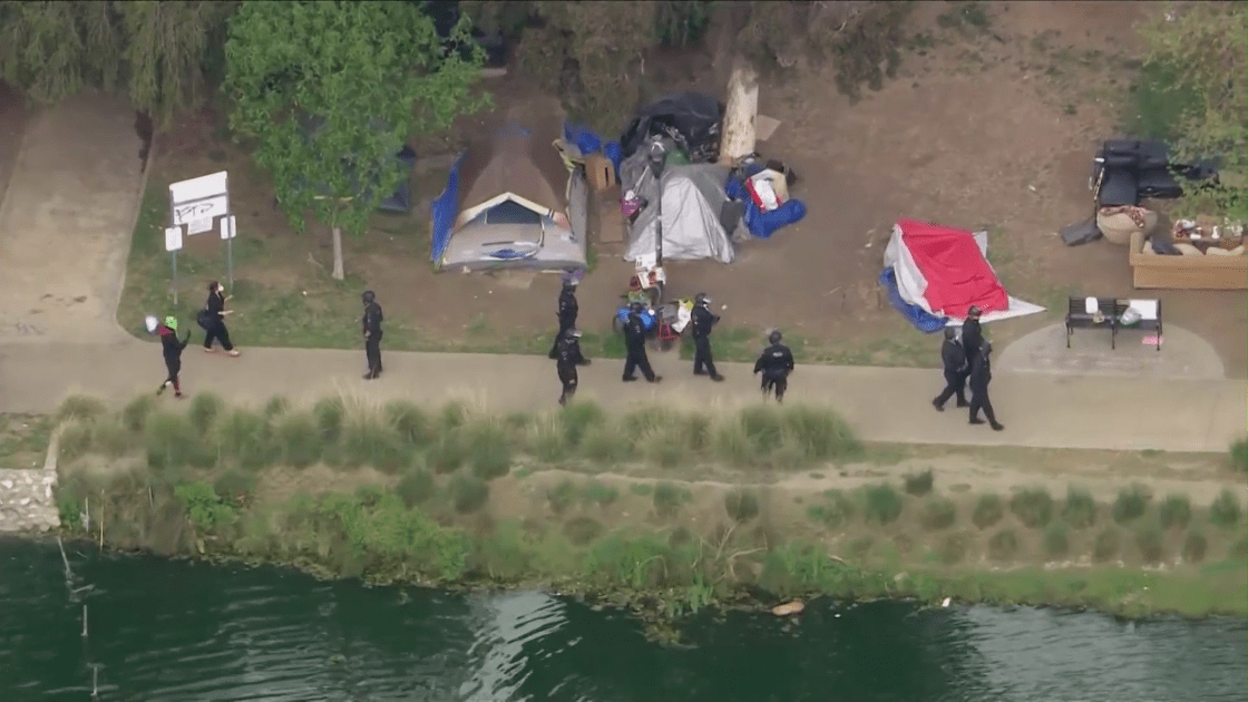 LAPD patrol Echo Park Lake amid a massive cleanup effort in March 2021. (KTLA)