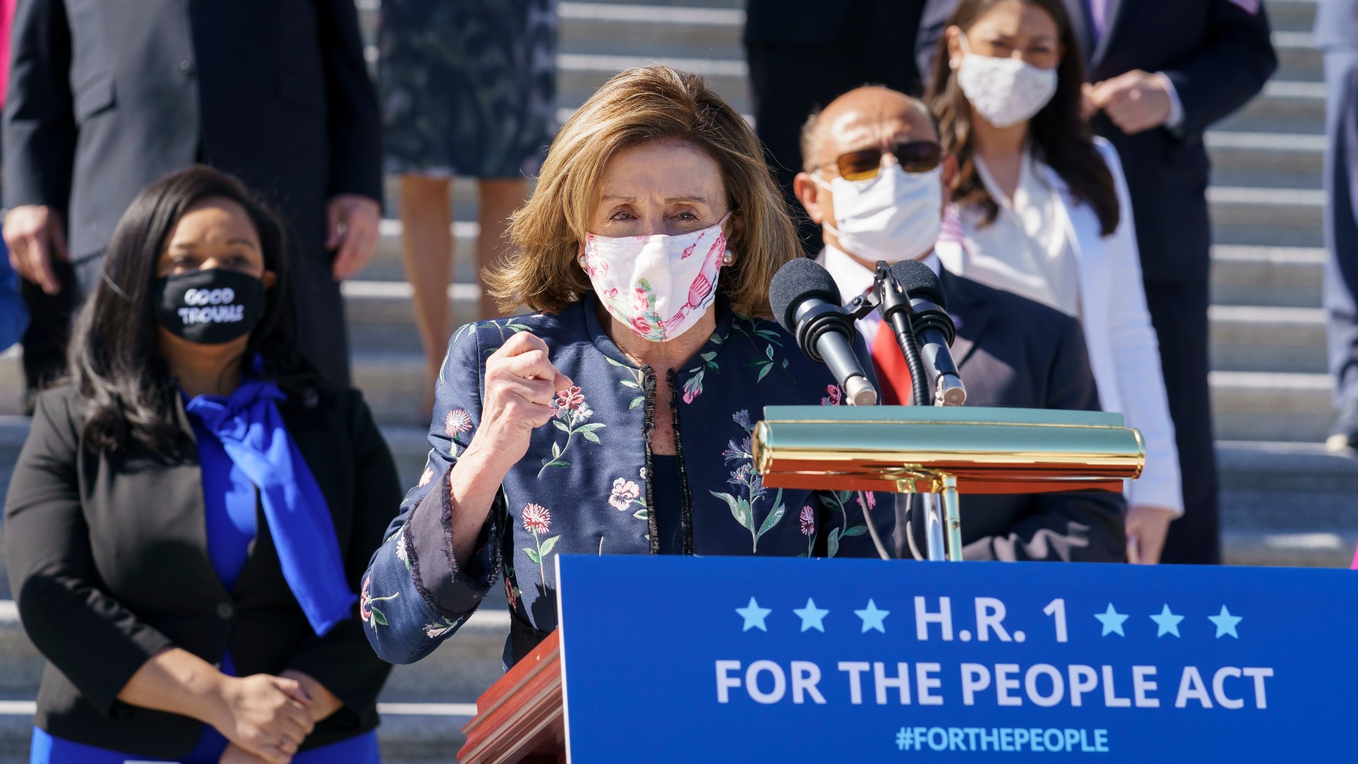 Speaker of the House Nancy Pelosi, D-Calif., and the Democratic Caucus gather to address reporters on H.R. 1, the For the People Act of 2021, at the Capitol in Washington, Wednesday, March 3, 2021. House Democrats are expected to pass a sweeping elections and ethics bill, offering it up as a powerful counterweight to voting rights restrictions advancing in Republican-controlled statehouses. (AP Photo/J. Scott Applewhite)