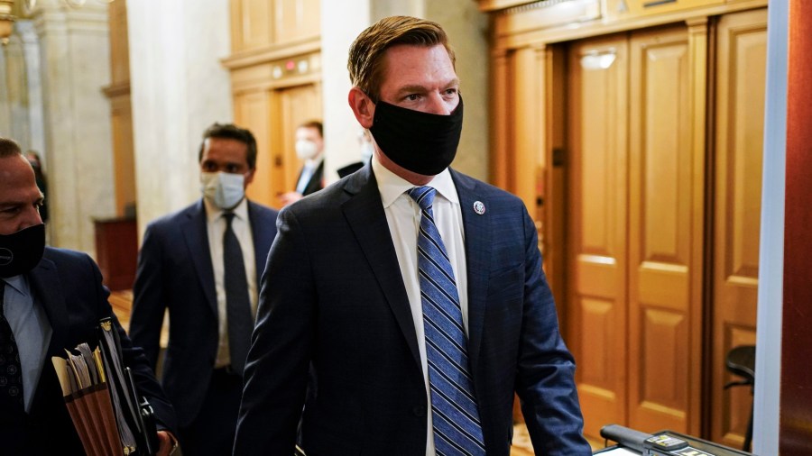 In this Feb. 10, 2021, file photo, Rep. Eric Swalwell, D-Calif., walks at the Capitol, in Washington. The House has rejected an attempt to boot a Democrat from the House intelligence committee. Democrats scuttled a Republican effort to remove Swalwell from the intelligence panel. The resolution against Swalwell cited reporting that he had contact more than six years ago with a suspected Chinese spy who targeted politicians in California. (Joshua Roberts/Pool via AP, File)