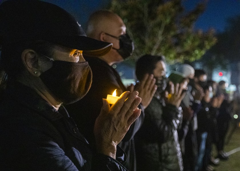 On March 23, 2021, people take part in a candlelight vigil at Community Center Park in Garden Grove, honoring the victims of the Atlanta-area spa shootings. (Allen J. Schaben / Los Angeles Times)