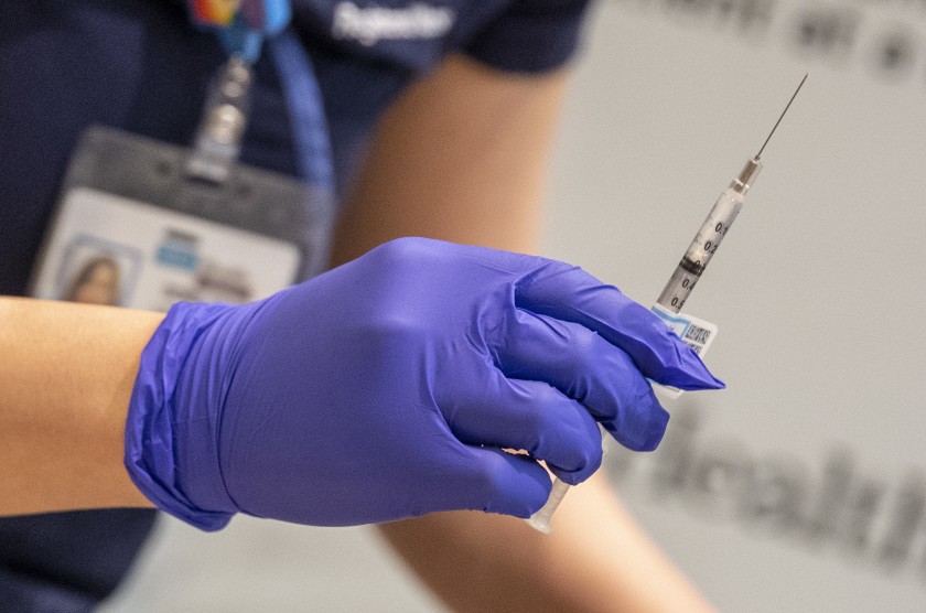 A nurse prepares a COVID-19 vaccine shot. The city of Pasadena canceled an upcoming clinic because too many unauthorized people had registered for inoculations.(Brian van der Brug / Los Angeles Times)