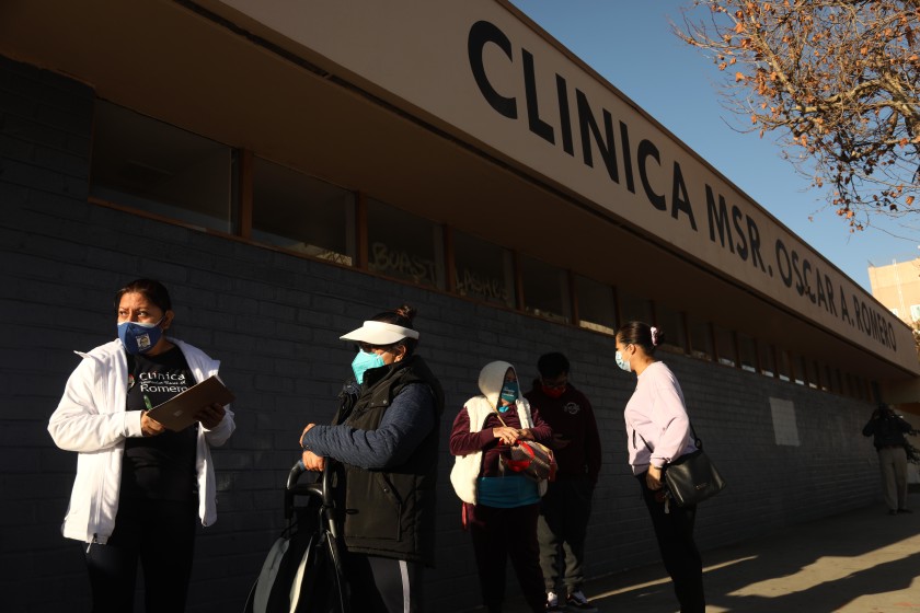 A staff member of Clinica Romero registers patients at a COVID-19 vaccination clinic.(Genaro Molina / Los Angeles Times)