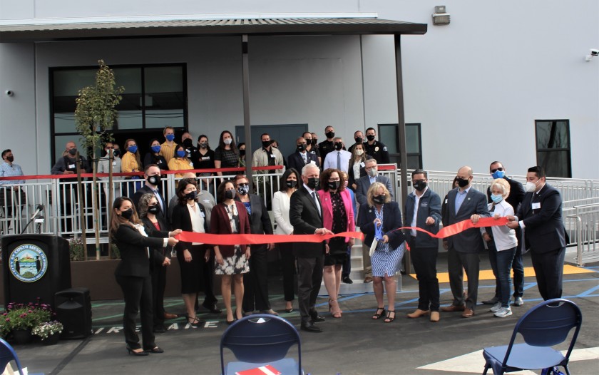 Costa Mesa officials celebrate the opening of a new homeless shelter on Airway Avenue in a ribbon-cutting ceremony March 23, 2021. (City of Costa Mesa via Los Angeles Times)