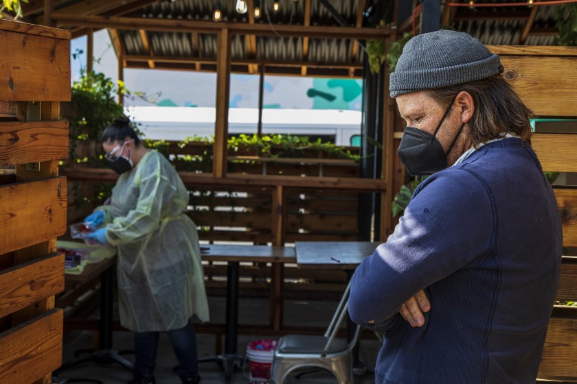 Owner Tyler Wells waits to be tested for COVID-19 earlier this year by a nurse hired by his restaurant, All Time, to test the staff.(Ricardo DeAratanha / Los Angeles Times)