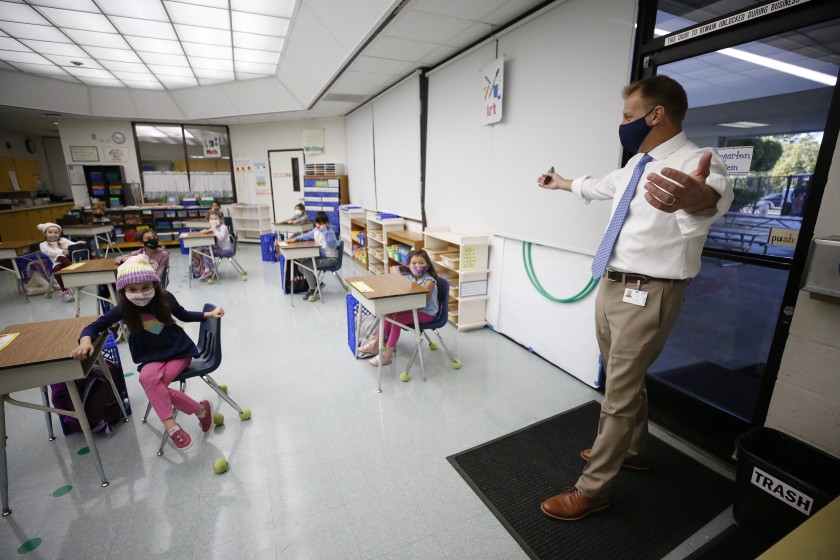 Las Virgenes Unified School District Superintendent Dan Stepenosky gives an air hug to students in a kindergarten class at Lupine Hill Elementary in Calabasas. (Al Seib / Los Angeles Times)