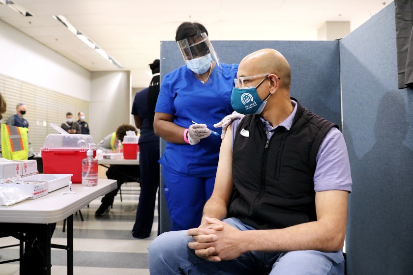 Dr. Mark Ghaly, secretary of the California Health and Human Services Agency, gets a one-dose Johnson & Johnson COVID-19 vaccine at the Baldwin Hills Crenshaw Plaza mall in Los Angeles on March 11, 2021. (Christina House / Los Angeles Times)