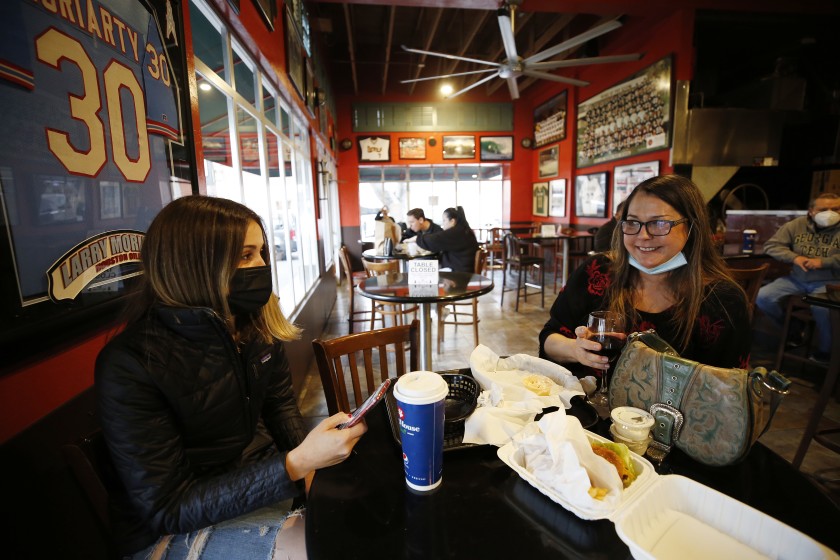 Brandi Harrapence, right, and daughter Kayla dine indoors at Firestone Grill in San Luis Obispo in this undated photo. The restaurant was open for indoor dining as San Luis Obispo County moved into a less restrictive tier of the state’s reopening plan on March 2021. (Al Seib/Los Angeles Times)