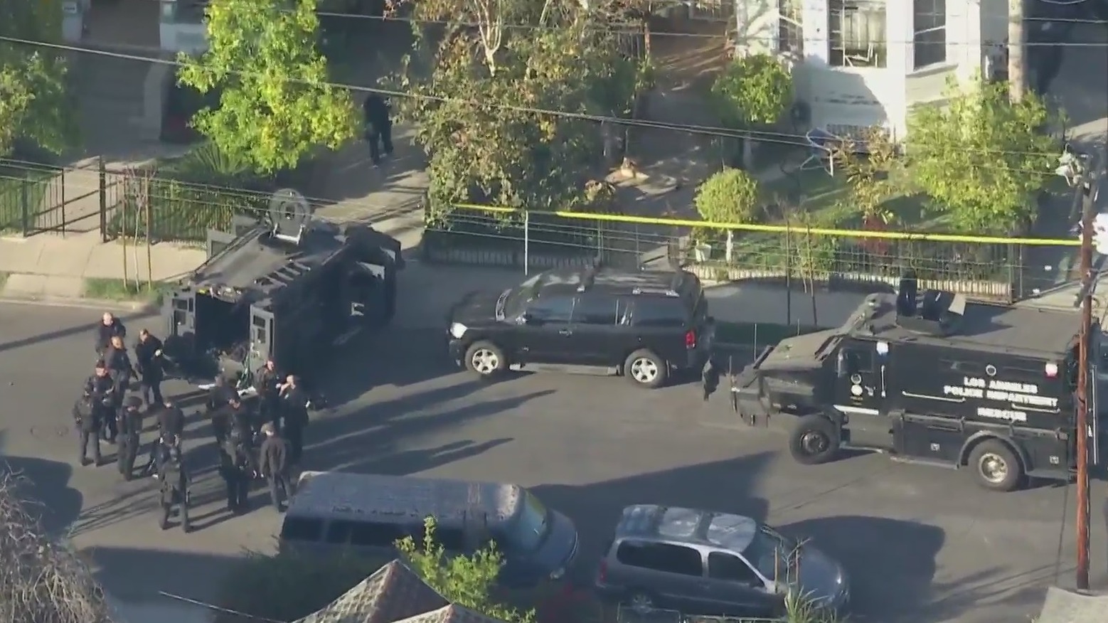 SWAT vehicles are stationed outside a University Park home following a police shooting on March 16, 2021. (KTLA)