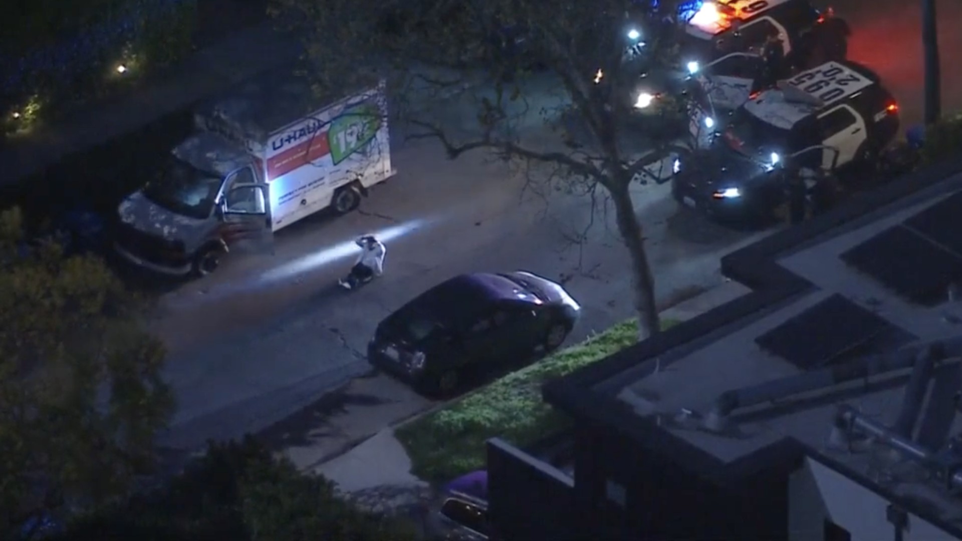 The driver of a stolen U-Haul truck surrenders in Hancock Park on March 26, 2021. (KTLA)