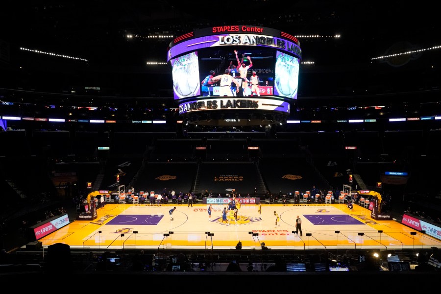 The Los Angeles Lakers and the Los Angeles Clippers tip off in an empty Staples Center amid the coronavirus pandemic, to start an NBA basketball game Dec. 22, 2020, in Los Angeles. (AP Photo/Marcio Jose Sanchez)