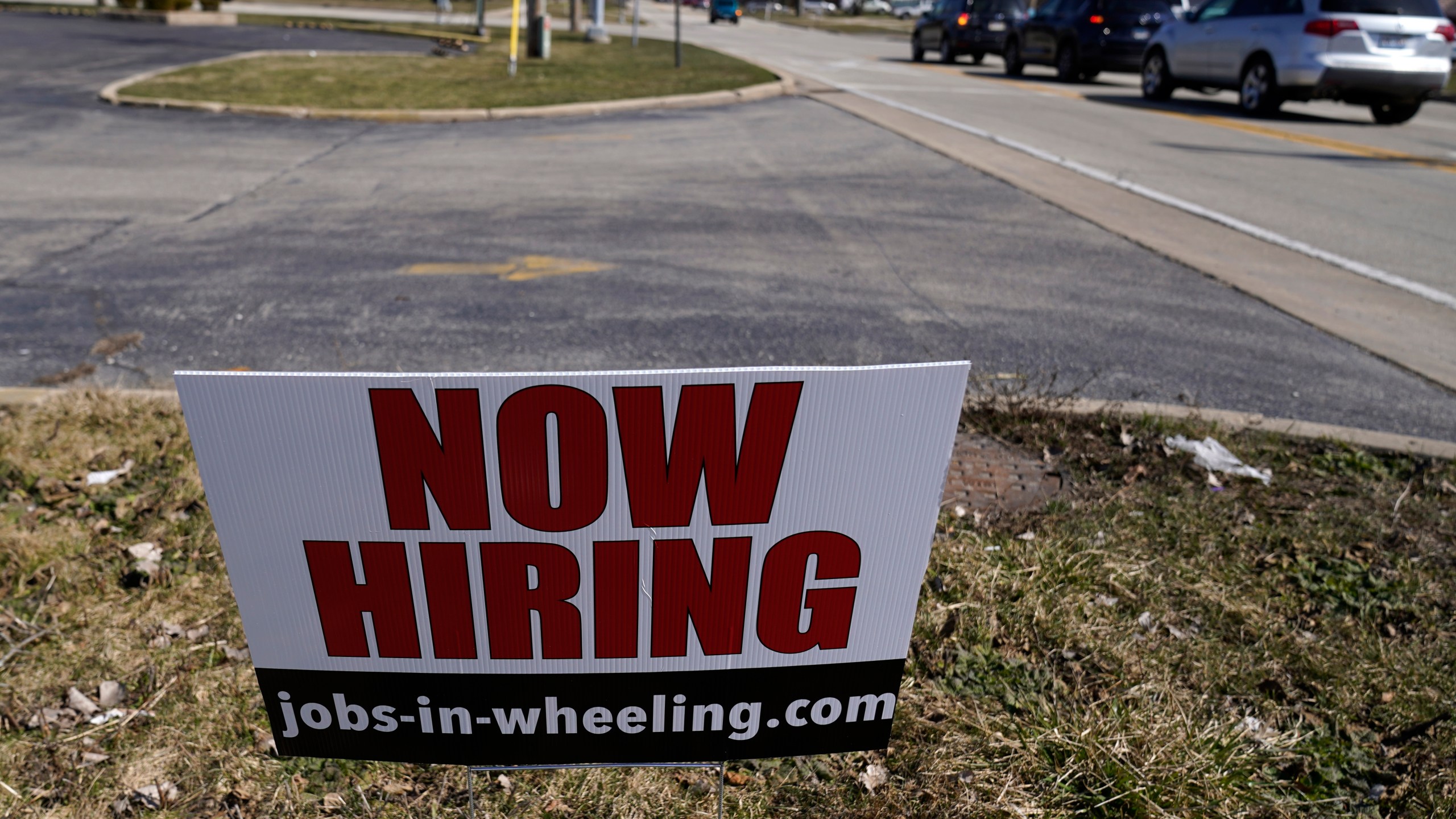 A hiring sign shows in Wheeling, Ill., Sunday, March 21, 2021. The number of Americans applying for unemployment aid fell last week to 547,000, a new low since the pandemic struck and a further encouraging sign that layoffs are slowing on the strength of an improving job market. The Labor Department said Thursday, April 22, that applications declined 39,000 from a revised 586,000 a week earlier. (AP Photo/Nam Y. Huh)