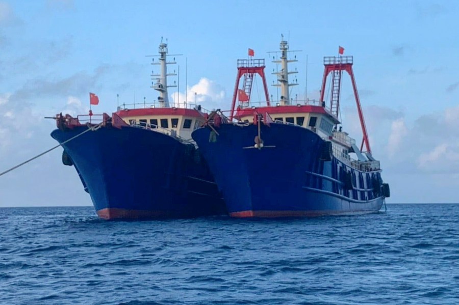 In this photo provided by the National Task Force-West Philippine Sea, Chinese vessels are moored at Whitsun Reef, South China Sea on March 27, 2021. (National Task Force-West Philippine Sea via AP)