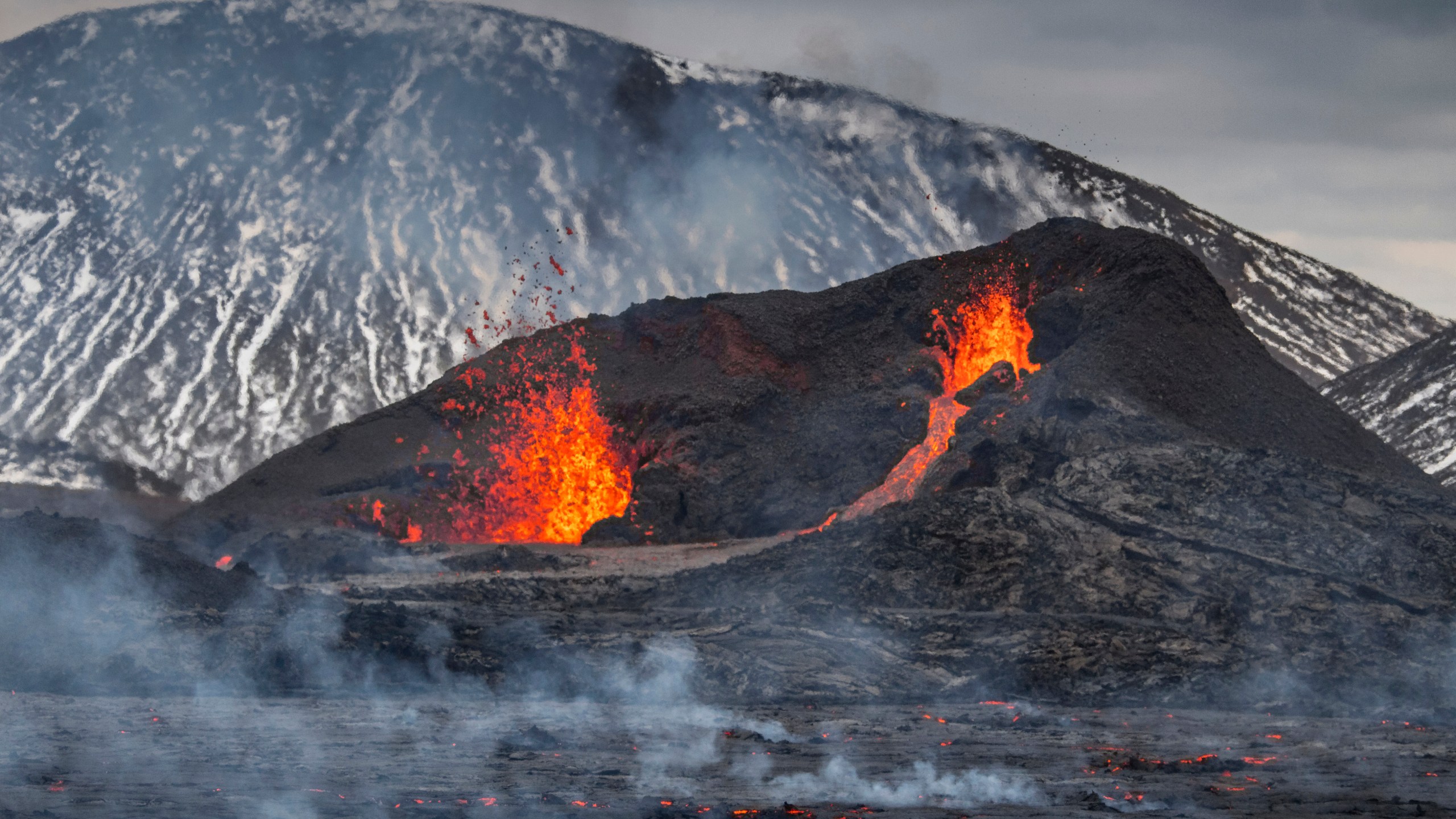 The Lava flows from an eruption of a volcano on the Reykjanes Peninsula in southwestern Iceland on Wednesday, March 31, 2021. Iceland's latest volcano eruption is still attracting crowds of people hoping to get close to the gentle lava flows. (AP Photo/Marco Di Marco)