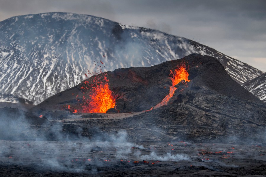 The Lava flows from an eruption of a volcano on the Reykjanes Peninsula in southwestern Iceland on Wednesday, March 31, 2021. Iceland's latest volcano eruption is still attracting crowds of people hoping to get close to the gentle lava flows. (AP Photo/Marco Di Marco)