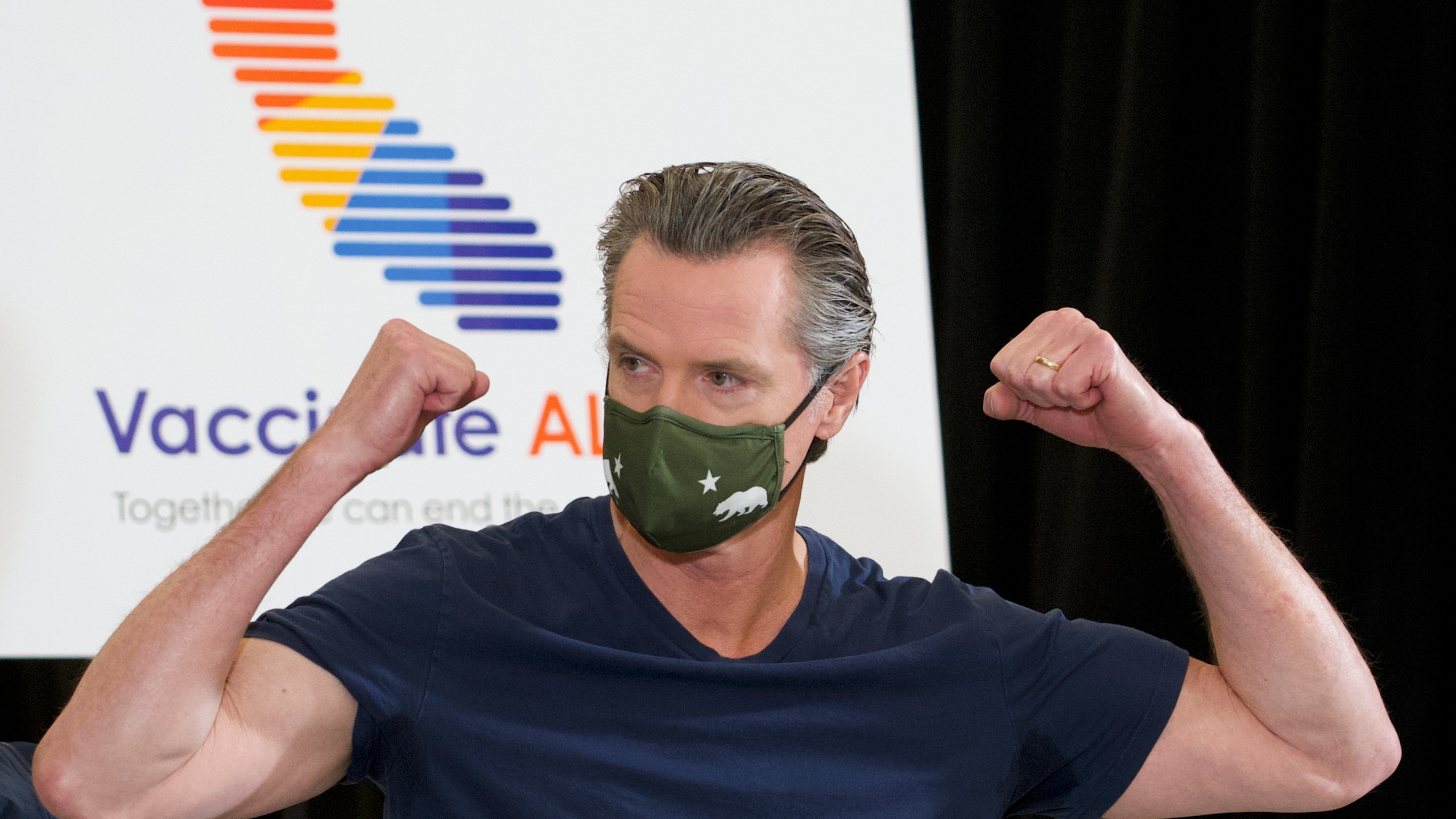 California Gov. Gavin Newsom reacts after being inoculated by Dr. Mark Ghaly, Secretary of California Health and Human Services, with the new one-dose Janssen COVID-19 vaccine at the Baldwin Hills Crenshaw Plaza in Los Angeles on April 1, 2021. (AP Photo/Damian Dovarganes)