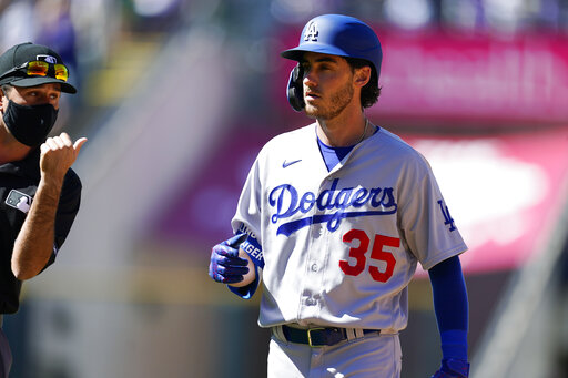 Los Angeles Dodgers' Cody Bellinger reacts after being called out after what he thought was a home run in the third inning of a baseball game against the Colorado Rockies Thursday, April 1, 2021, in Denver. (AP Photo/David Zalubowski)