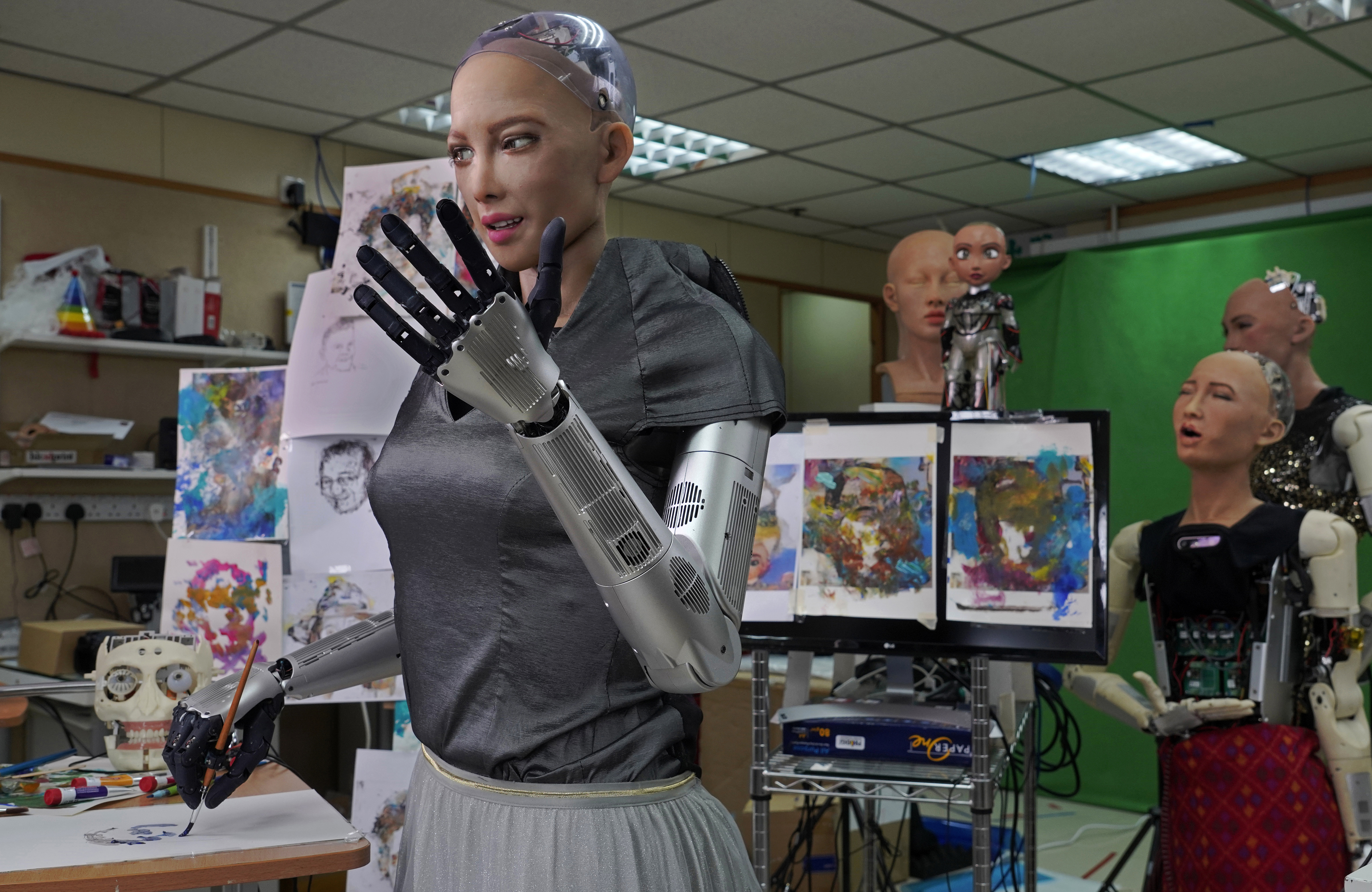 Sophia uses a brush to paint at Hanson Robotics studio in Hong Kong on March 29, 2021. (AP Photo/Vincent Yu)