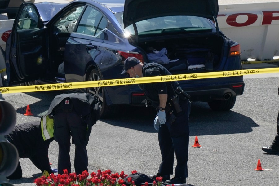 U.S. Capitol Police officers investigate near a car that crashed into a barrier on Capitol Hill near the Senate side fo the U.S. Capitol in Washington, Friday, April 2, 2021. (AP Photo/J. Scott Applewhite)