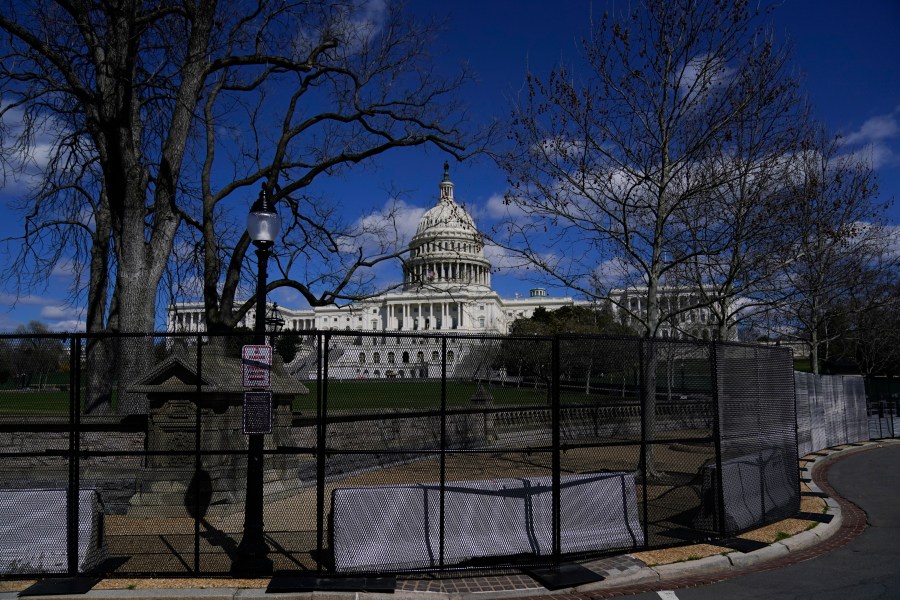 The U.S. Capitol is seen behind security fencing after a car that crashed into a barrier on Capitol Hill in Washington, Friday, April 2, 2021. (AP Photo/Carolyn Kaster)