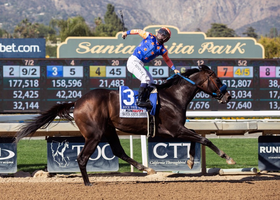 In a photo provided by Benoit Photo, Rock Your World and jockey Umberto Rispoli win the Grade I $750,000 Santa Anita Derby Saturday, April 3, 2021 at Santa Anita Park in Arcadia, Calif. (Benoit Photo via AP)