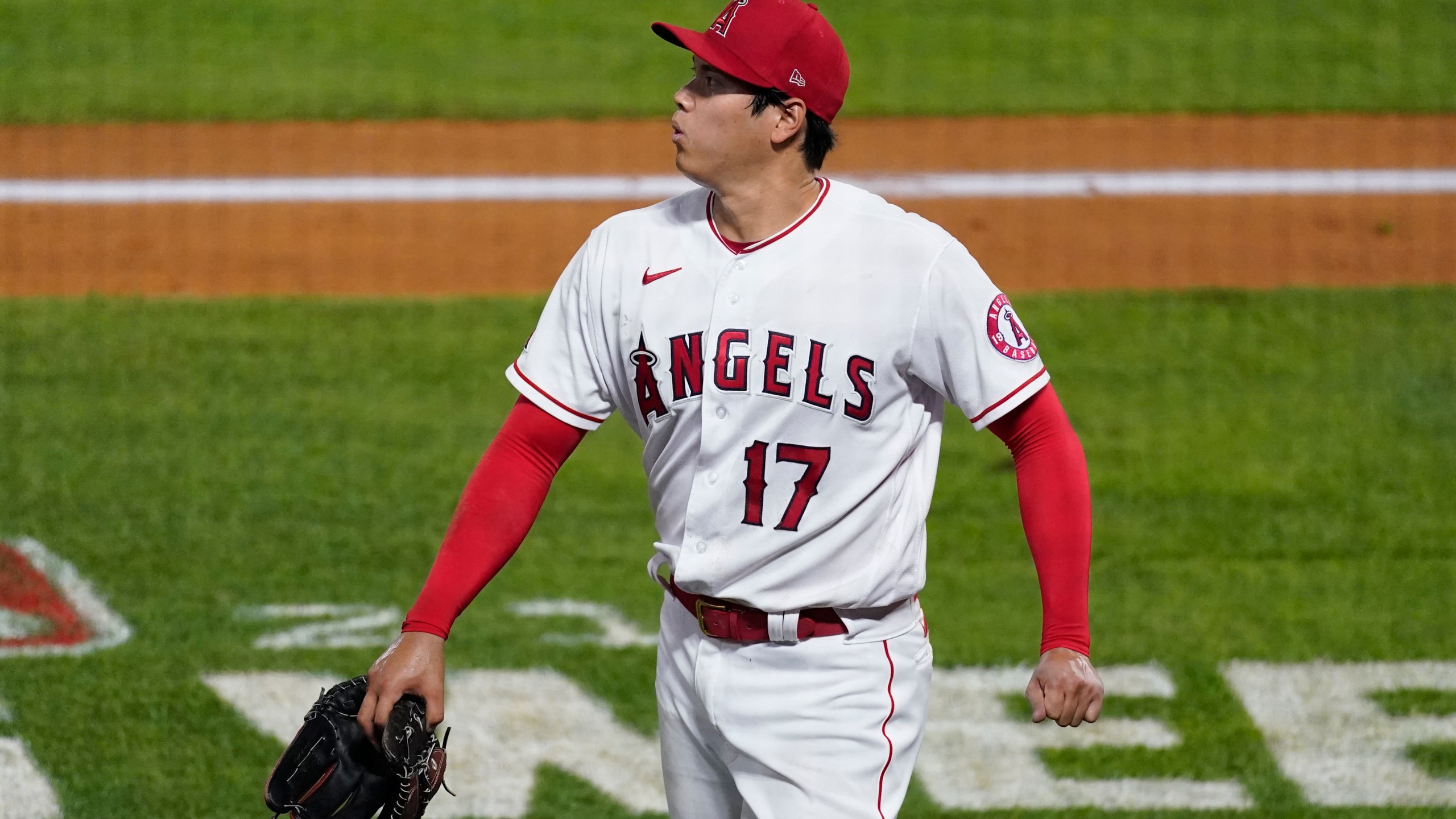 Los Angeles Angels starting pitcher Shohei Ohtani walks off the field during the fifth inning of the team's baseball game against the Chicago White Sox on Sunday, April 4, 2021, in Anaheim, Calif. (AP Photo/Ashley Landis)