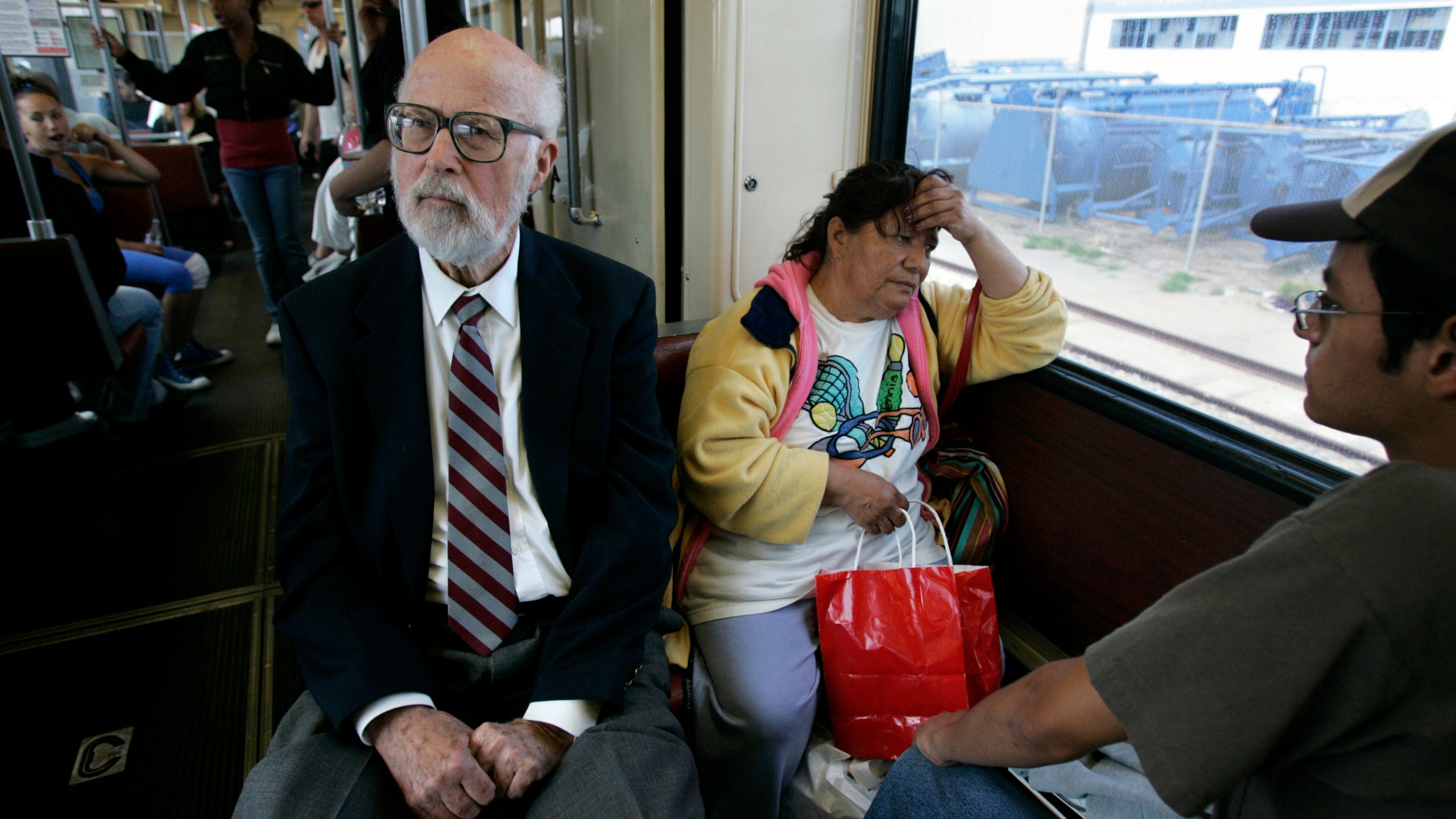 In this in May 2, 2007, photo, California state legislator James Mills, father of the San Diego Trolley, rides the Blue Line in San Diego. (Laura Embry/The San Diego Union-Tribune via AP, File)