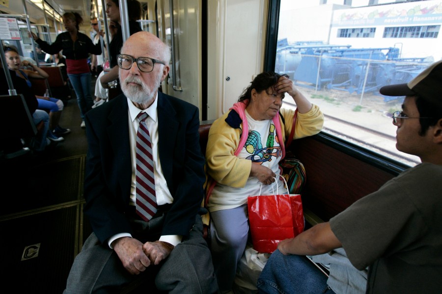 In this in May 2, 2007, photo, California state legislator James Mills, father of the San Diego Trolley, rides the Blue Line in San Diego. (Laura Embry/The San Diego Union-Tribune via AP, File)