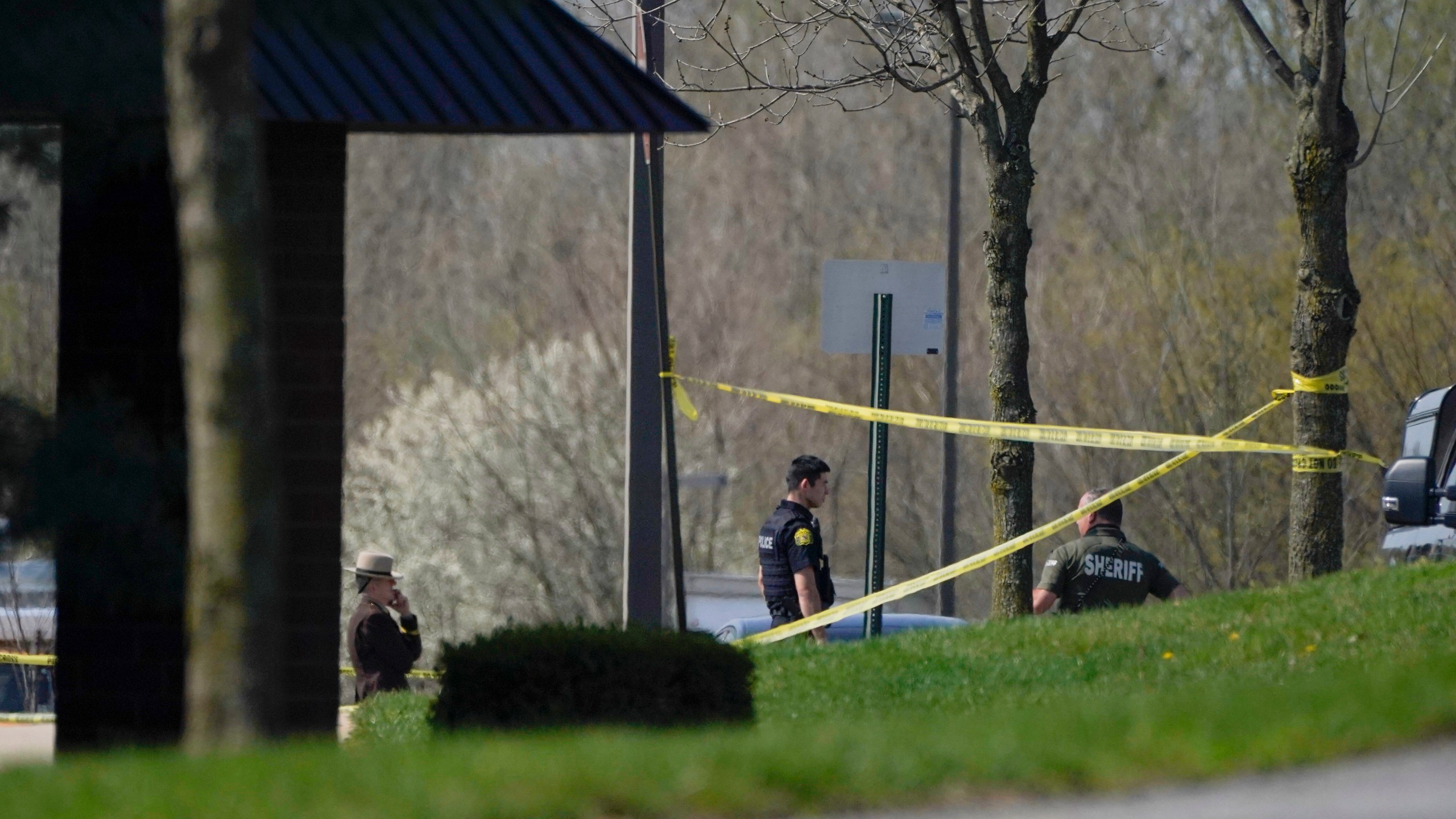 Police stand around an area cordoned off by police tape on Progress Court, near the scene of a shooting at a business park, in Frederick, Md., Tuesday, April 6, 2021. (AP Photo/Julio Cortez)