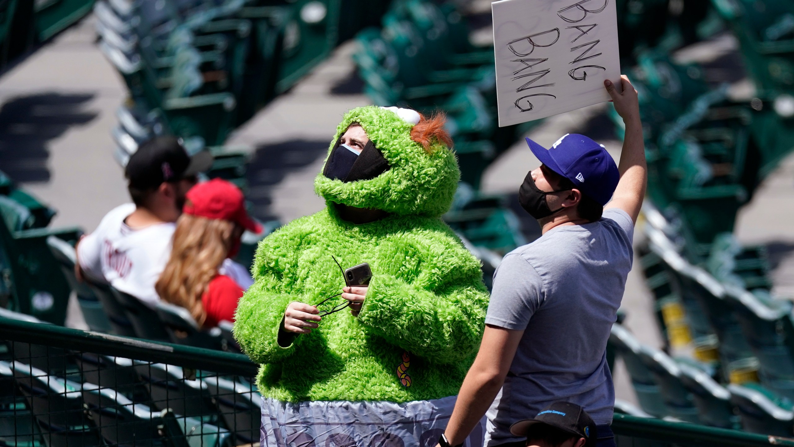 A fan wears an Oscar the Grouch costume as he taunts the Houston Astros prior to a baseball game against the Los Angeles Angels Tuesday, April 6, 2021, in Anaheim, Calif. (AP Photo/Mark J. Terrill)