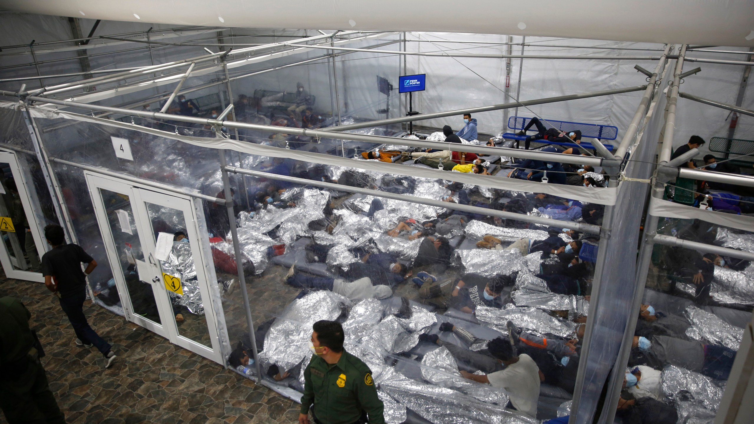 In this March 30, 2021, file photo, young minors lie inside a pod at the Donna Department of Homeland Security holding facility, the main detention center for unaccompanied children in the Rio Grande Valley run by U.S. Customs and Border Protection (CBP), in Donna, Texas. U.S. authorities say they picked up nearly 19,000 children traveling alone across the Mexican border in March. It's the largest monthly number ever recorded and a major test for President Joe Biden as he reverses many of his predecessor's hardline immigration tactics. (AP Photo/Dario Lopez-Mills, Pool, File)