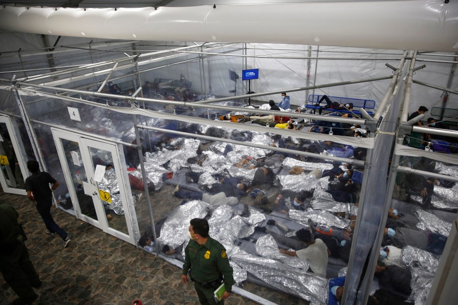 In this March 30, 2021, file photo, young minors lie inside a pod at the Donna Department of Homeland Security holding facility, the main detention center for unaccompanied children in the Rio Grande Valley run by U.S. Customs and Border Protection (CBP), in Donna, Texas. U.S. authorities say they picked up nearly 19,000 children traveling alone across the Mexican border in March. It's the largest monthly number ever recorded and a major test for President Joe Biden as he reverses many of his predecessor's hardline immigration tactics. (AP Photo/Dario Lopez-Mills, Pool, File)