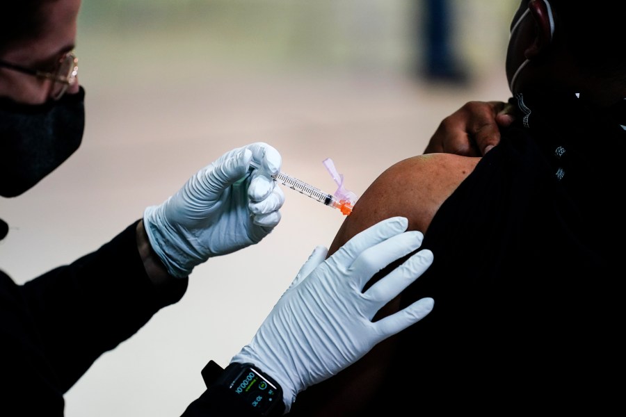 In this March 26, 2021, file photo, a member of the Philadelphia Fire Department administers the Johnson & Johnson COVID-19 vaccine to a person at a vaccination site at a Salvation Army location in Philadelphia. (AP Photo/Matt Rourke, File)