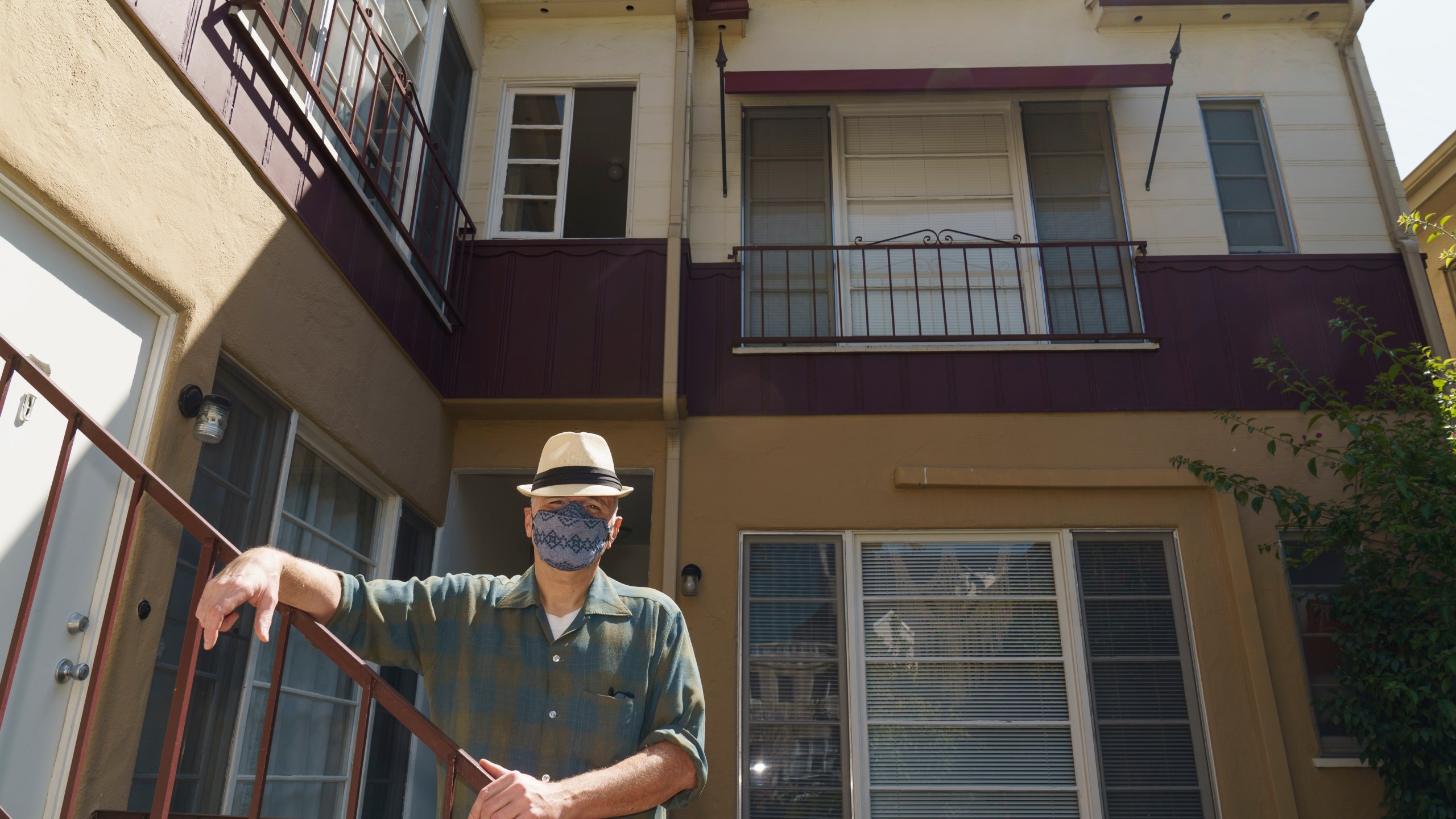 Nathan Long, a video game writer, poses for a picture outside his rental apartment courtyard in Glendale on April 8, 2021. He and his wife, Lili, have been unsuccessful so far in their search for a home in Los Angeles. (AP Photo/Damian Dovarganes)