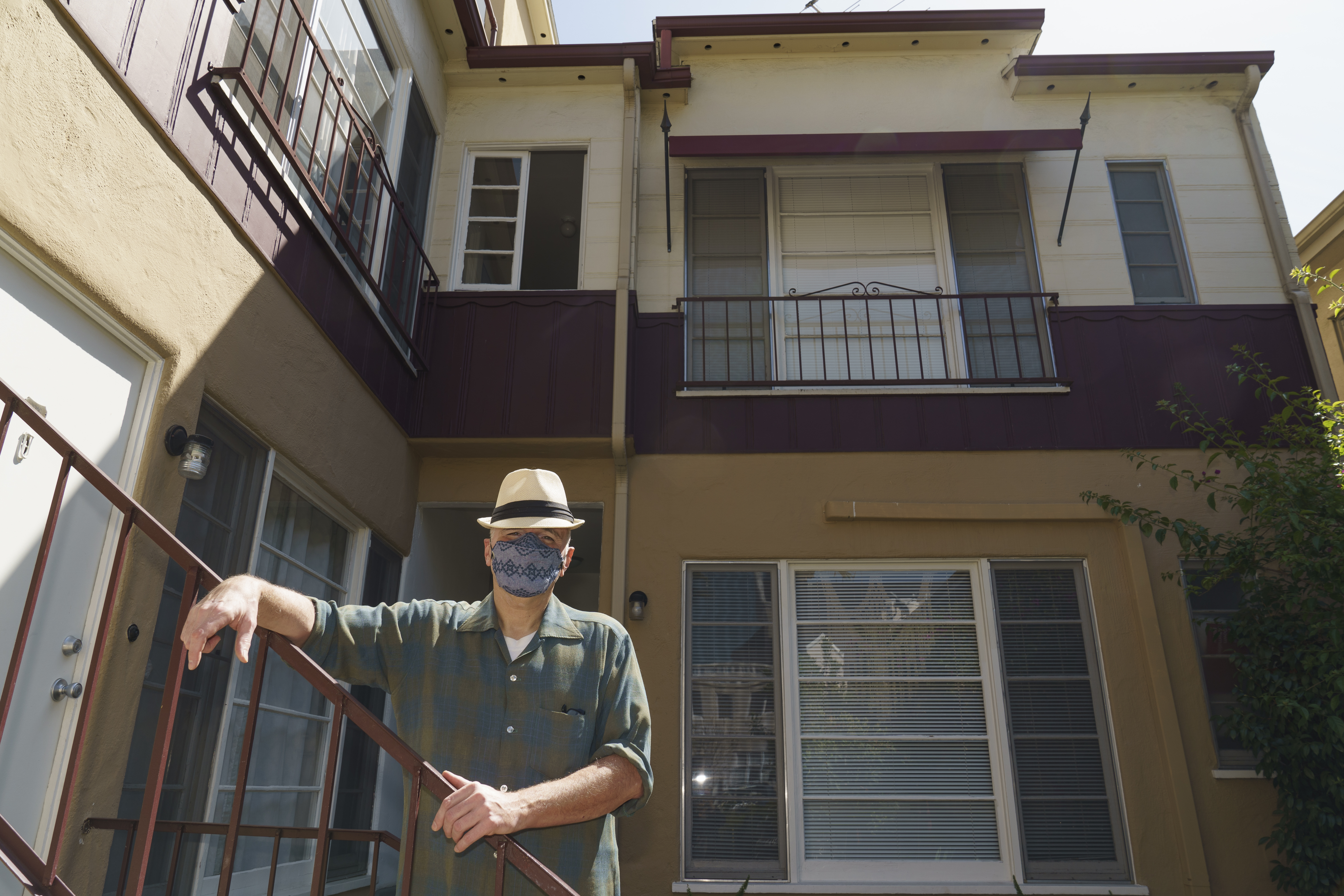 Nathan Long, a video game writer, poses for a picture outside his rental apartment courtyard in Glendale on April 8, 2021. He and his wife, Lili, have been unsuccessful so far in their search for a home in Los Angeles. (AP Photo/Damian Dovarganes)