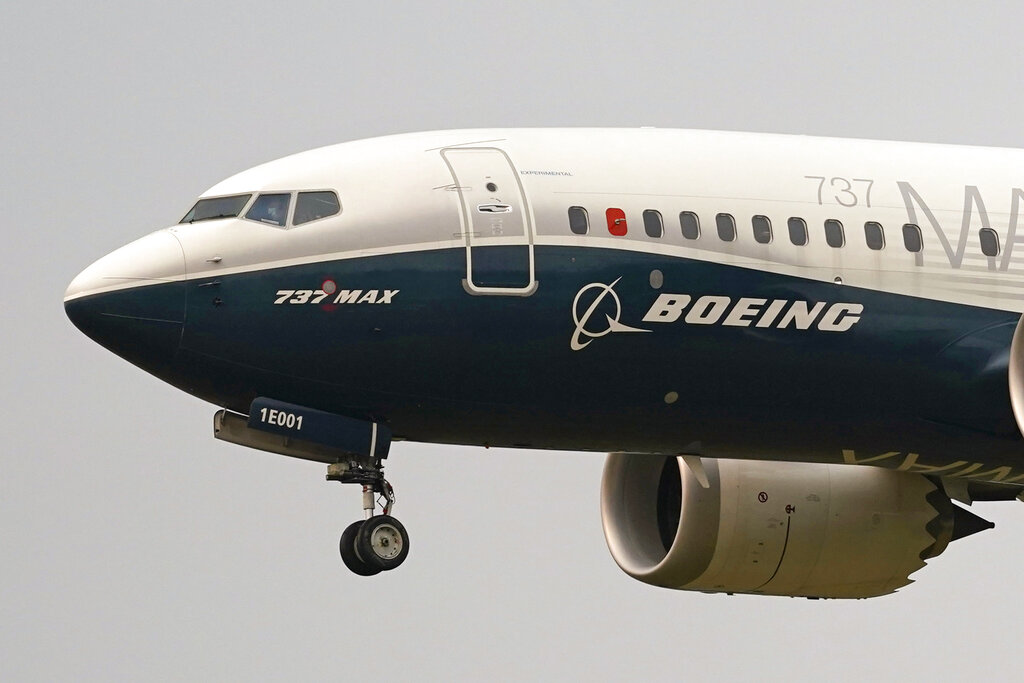 In this Sept. 30, 2020, file photo, a Boeing 737 Max jet, piloted by Federal Aviation Administration (FAA) chief Steve Dickson, prepares to land at Boeing Field following a test flight in Seattle. (AP Photo/Elaine Thompson, File)