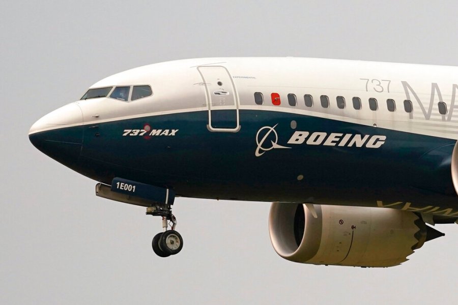 In this Sept. 30, 2020, file photo, a Boeing 737 Max jet, piloted by Federal Aviation Administration (FAA) chief Steve Dickson, prepares to land at Boeing Field following a test flight in Seattle. (AP Photo/Elaine Thompson, File)