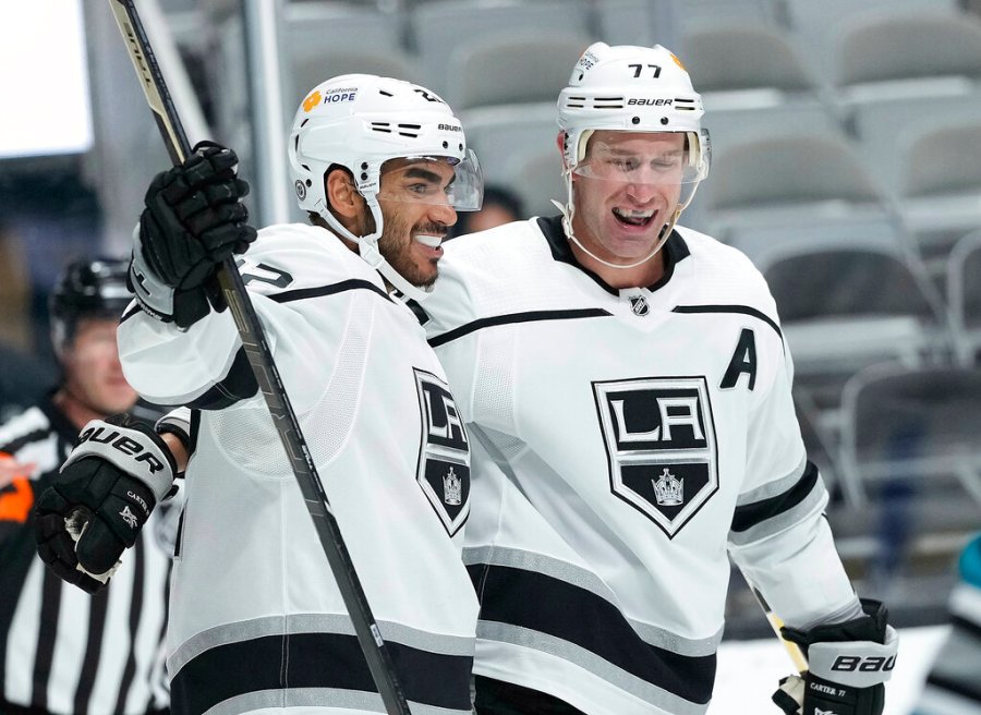 Los Angeles Kings left wing Andreas Athanasiou (22) celebrates with center Jeff Carter (77) after scoring a gaol against the San Jose Sharks during the second period of an NHL hockey game Saturday, April 10, 2021, in San Jose, Calif. (AP Photo/Tony Avelar)