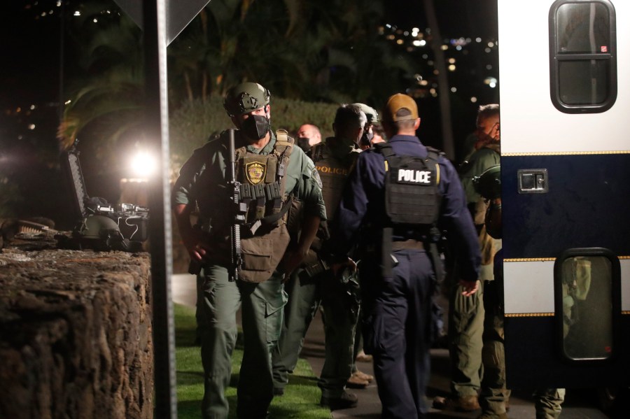 Members of the Honolulu Police Specialized Services Division respond to a barricade situation with an armed man at the Kahala Hotel in Honolulu on Saturday, April 10, 2021. The armed man barricaded himself inside a hotel room at the resort in Honolulu and fired shots through the door, a police official said. (Cindy Ellen Russell/Honolulu Star-Advertiser via AP)