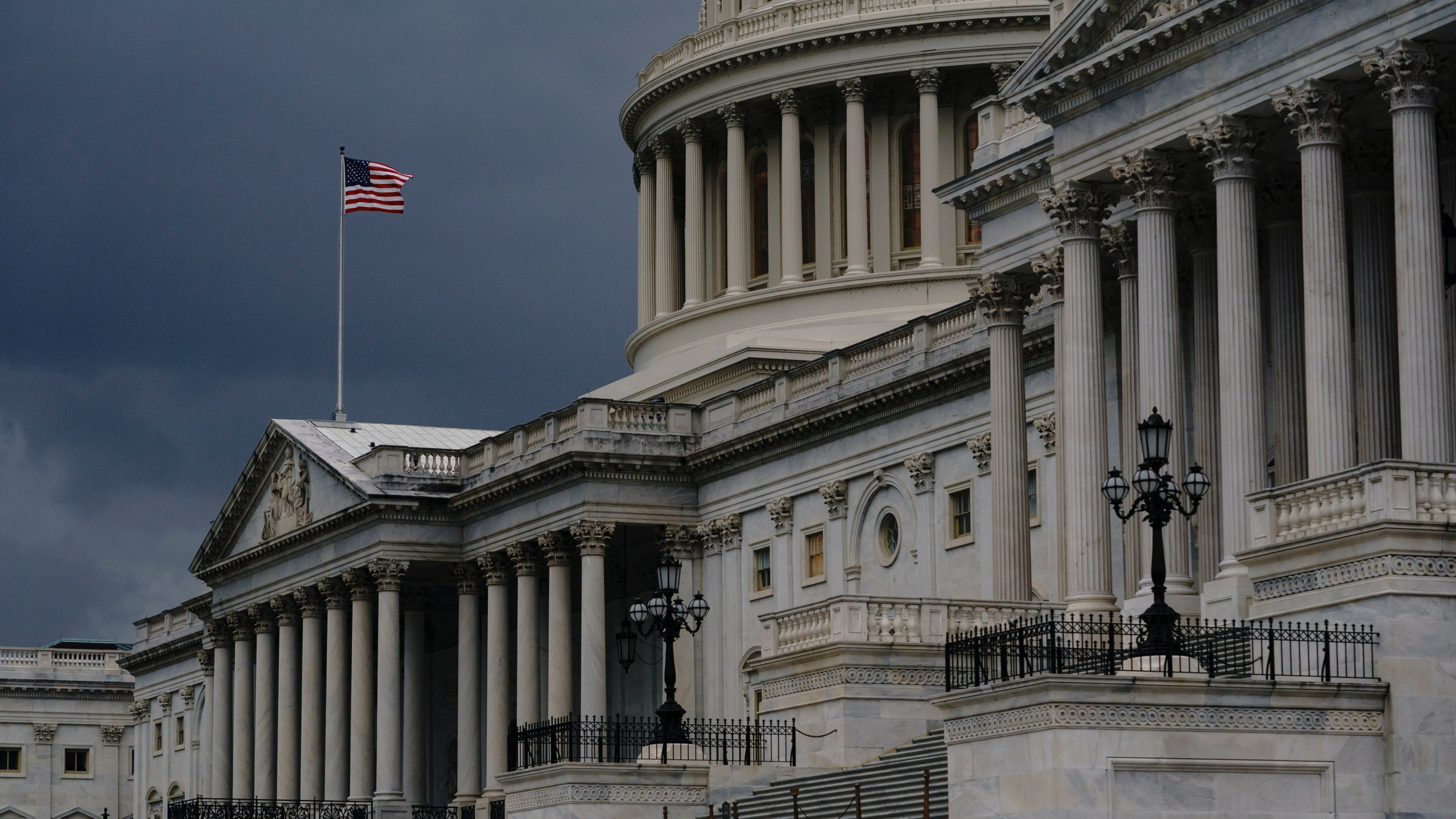 In this Aug. 3, 2020, file photo dark clouds and heavy rain sweep over the U.S. Capitol in Washington. The U.S. government's budget deficit surged to an all-time high of $1.7 trillion for the first six months of this budget year, nearly double the previous record, as another round of economic-support checks added billions of dollars to spending last month. (AP Photo/J. Scott Applewhite, File)