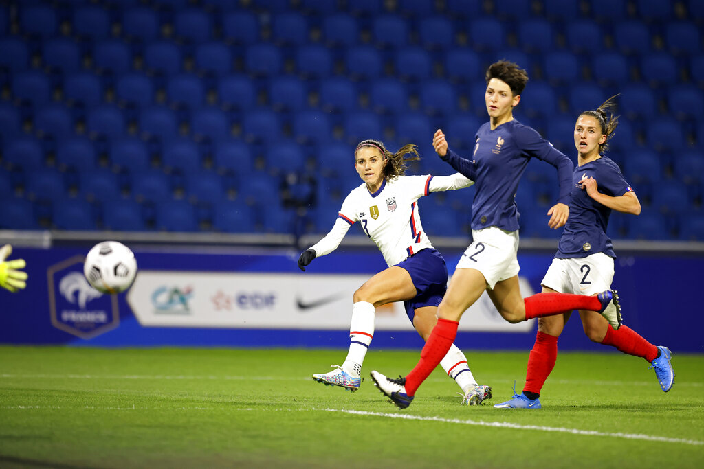 United States' Alex Morgan (13) scores a goal against France during an international friendly women's soccer match between the United States and France in Le Havre, France, Tuesday, April 13, 2021. (AP Photo/David Vincent)